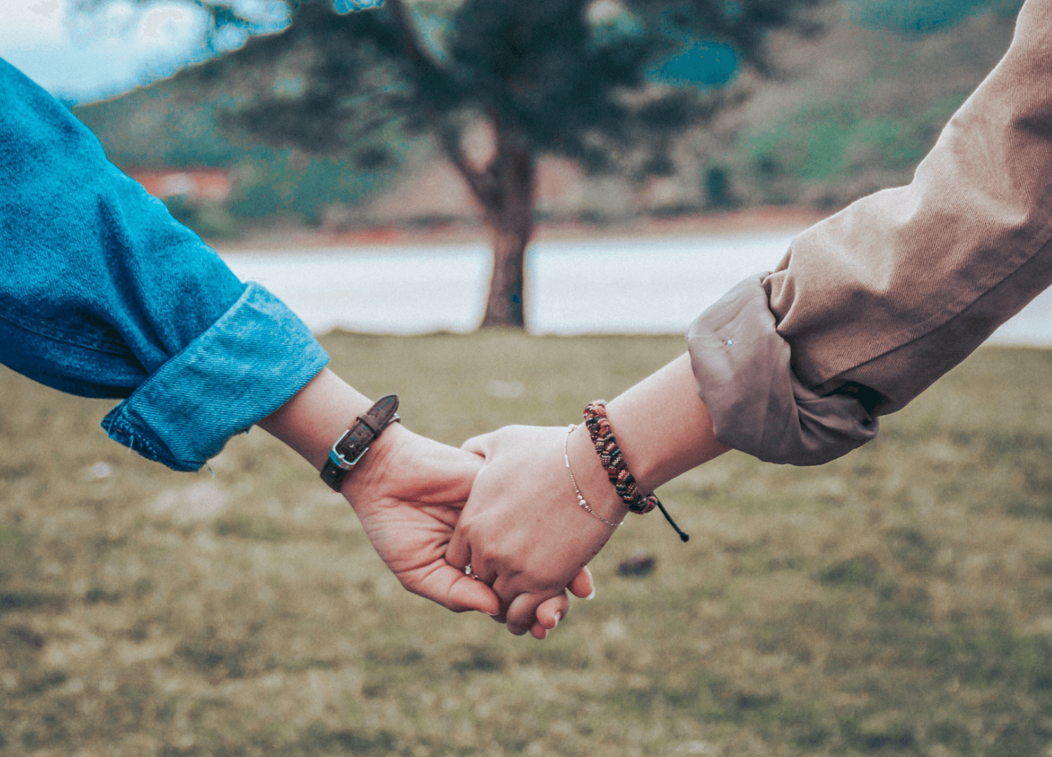 Two persons holding hands