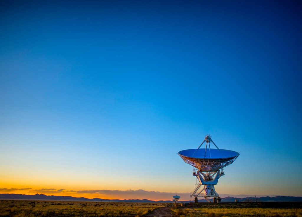 Radio telescope in the foreground of a beautiful sunset